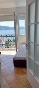 a bedroom with an open door with a view of the ocean at Lala in Herceg-Novi