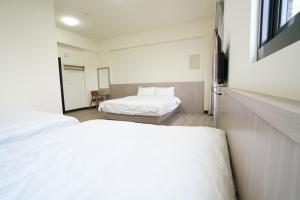 Postel nebo postele na pokoji v ubytování 享悅電梯民宿