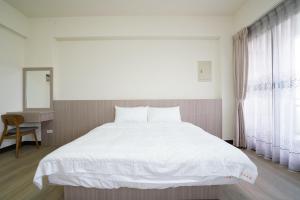 Postel nebo postele na pokoji v ubytování 享悅電梯民宿