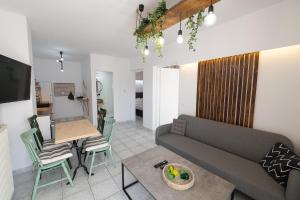 a living room with a couch and a table at Camo’s house in Poros