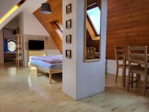 a room with a bed and a dining room at Pension Family in Karlovy Vary