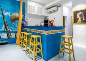 a blue bar with stools in a room at Chihkan Mansion in Tainan