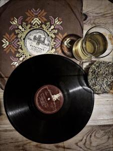 a vinyl record next to a bottle of whiskey at Tevra Guesthouse & Teahouse in Getahovit