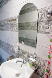 a bathroom with a sink and a mirror at Tevra Guesthouse & Teahouse in Getahovit