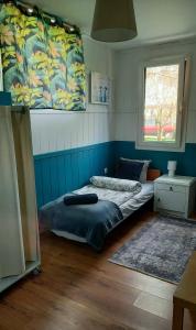 two beds in a room with blue walls at Domek Wilamów in Wilamów