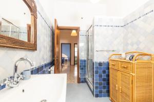 a bathroom with a sink and a shower at Coastal Home in Santa Maria Navarrese
