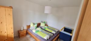 a bedroom with a bed with pillows on it at Am Walde in Trassenheide