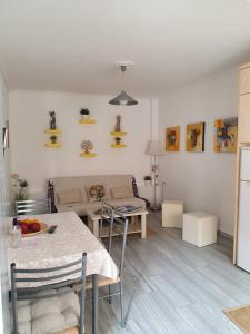 a living room with a table and a couch at Kalamia's cozy apartment in Pyrgos