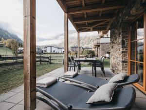 a patio with a table and chairs on it at VAYA Kaprun inklusive Zell am See Kaprun Sommer Karte in Kaprun