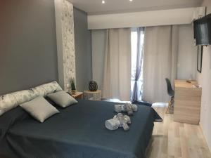 a bedroom with a bed with stuffed animals on it at RHODIAN TREASURE Spiridione studio 1 in Faliraki