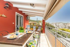 a balcony with a table and chairs with food on it at Coastal Home in Santa Maria Navarrese