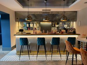 a kitchen with chairs, tables, and chairs in it at Hotel 55 in London