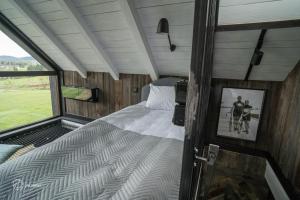 a bedroom with a bed and a window in a house at Szopa in Ustrzyki Dolne