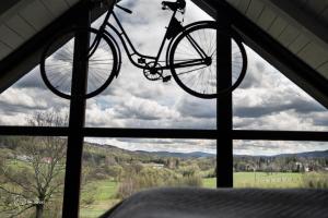a bike hanging from a window in a bedroom at Szopa in Ustrzyki Dolne