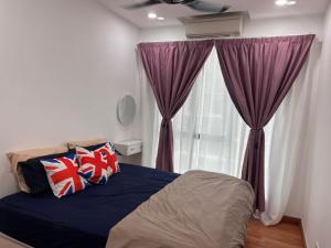 a bedroom with a bed with purple curtains and a window at Pangsapuri Putra Mewah in Johor Bahru +9 photos