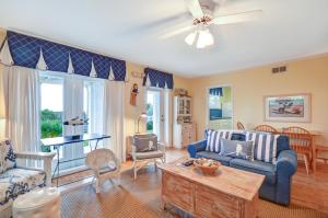 a living room with a couch and a table at DogFriendly Duplex in Fernandina Beach