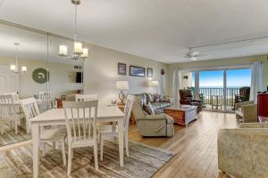 a dining room and living room with a table and chairs at Amelia South Beach Condo in Fernandina Beach