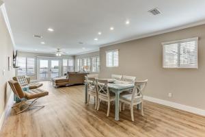 a dining room and living room with a table and chairs at Beach House w Backyard in Fernandina Beach