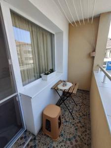 a room with a window and a dog house on the floor at Apartment Serkyovi in Pomorie +3 photos