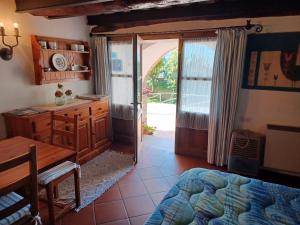 a bedroom with a desk and a bed and a table at LE PIANACCE - Appartamento per vacanze in Castiglione di Garfagnana