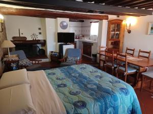 1 dormitorio con 1 cama y comedor en LE PIANACCE - Appartamento per vacanze, en Castiglione di Garfagnana