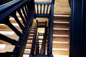 an overhead view of a spiral staircase with wooden floors at Hôtel Le Windsor Biarritz in Biarritz