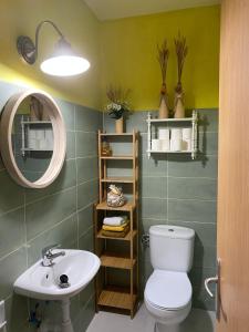 a bathroom with a toilet and a sink and a mirror at Eterna Primavera, a 40m de la piscina natural in Punta Mujeres +41 photos