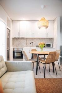 a kitchen with a table and chairs and a couch at Casa dos Capuchos in Leiria