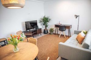 a living room with a couch and a table at Casa dos Capuchos in Leiria