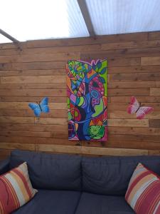 um sofá num quarto com borboletas na parede em Sweet home vintage em Charleroi
