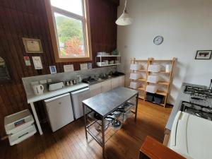 cocina con mesa y encimera en Helmsdale Lodge Hostel - all rooms en-suite, en Helmsdale