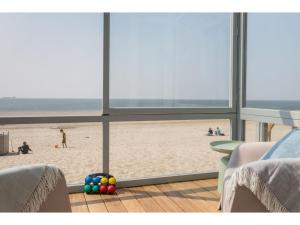 a living room with a view of the beach at Cottage on the beach of Dishoek in Dishoek