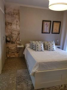 a bedroom with a bed and a wall with drawings at MRZ RENTALS JEREZ in Jerez de la Frontera