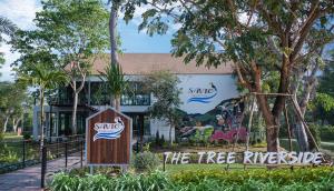 a building with a sign in front of it at The Tree Riverside Kaeng Krachan in Kaeng Krachan