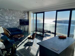 a living room with a view of the ocean at Apartments Fortes Fortuna in Dubrovnik