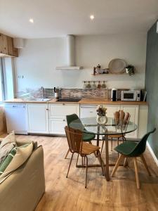 - une cuisine avec une table et des chaises dans la chambre dans l'établissement La Fabrique Centre ville - Berges du Tarn, à Millau
