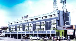 a large building with people standing outside of it at Rudra Shelter Business Hotel in Vasai