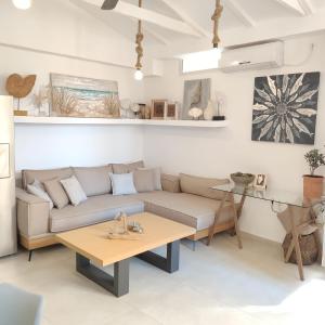 a living room with a couch and a table at Waterside Apartments in Agia Effimia