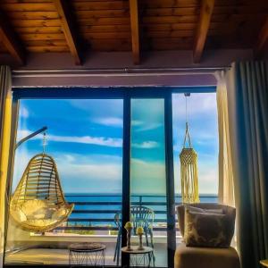 a room with a large window with a view of the ocean at Hotel Natali in Dhërmi