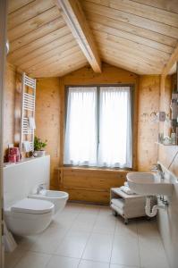 a bathroom with two sinks and a toilet and a window at Turin Sweet Home in Turin