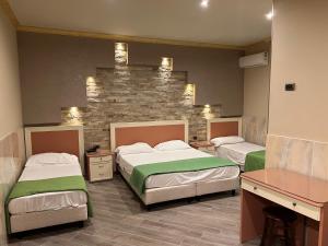 Postel nebo postele na pokoji v ubytování Hotel Iris