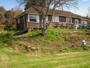 a house on a hill with a tree in front of it at Holiday Home Lochness by Interhome in Contin