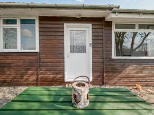 a house with a front door with a tire in front at Holiday Home Lochness by Interhome in Contin