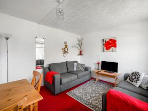 a living room with a couch and a table at Holiday Home Lochness by Interhome in Contin +17 photos