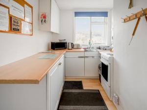 a kitchen with white cabinets and a counter top at Holiday Home Lochness by Interhome in Contin