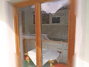 a view of a kitchen through a glass window at Apartment Schimpfössl Katharina-1 by Interhome in Sankt Anton am Arlberg