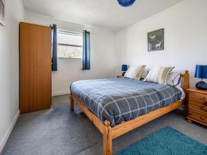 a bedroom with a bed and a dresser and a window at Holiday Home Isle of Skye by Interhome in Contin