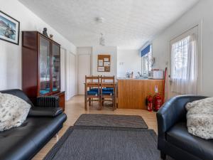 a living room with a couch and a table at Holiday Home Isle of Skye by Interhome in Contin +15 photos