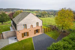 an aerial view of a large brick house in a field at La Rigaudrye in Ellezelles