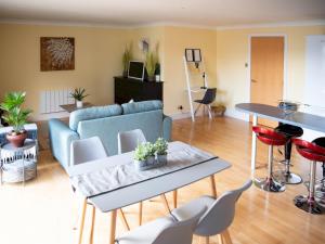 a living room with a couch and a table and chairs at Pass the Keys Lovely 2-bed in Perfect City Location with Parking in Glasgow